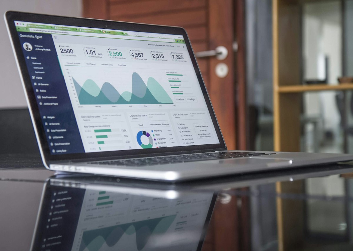 Charts and laptop screen used to review independent contractor cash flow